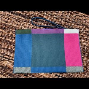 Rothy’s  bright big check essential pouch.